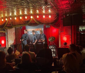 Three comedians performing on a stage