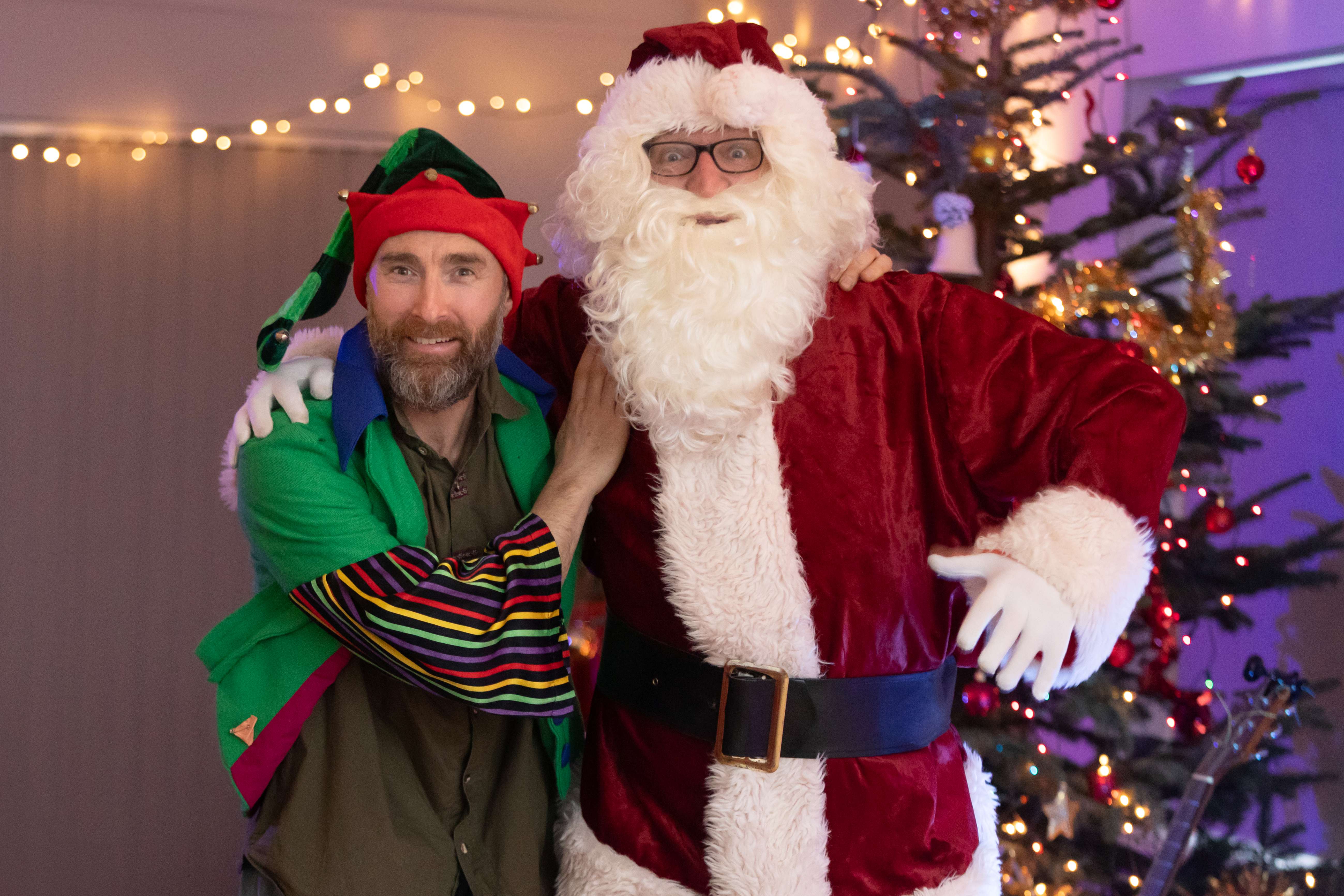 Santa and his Helper in front of the tree