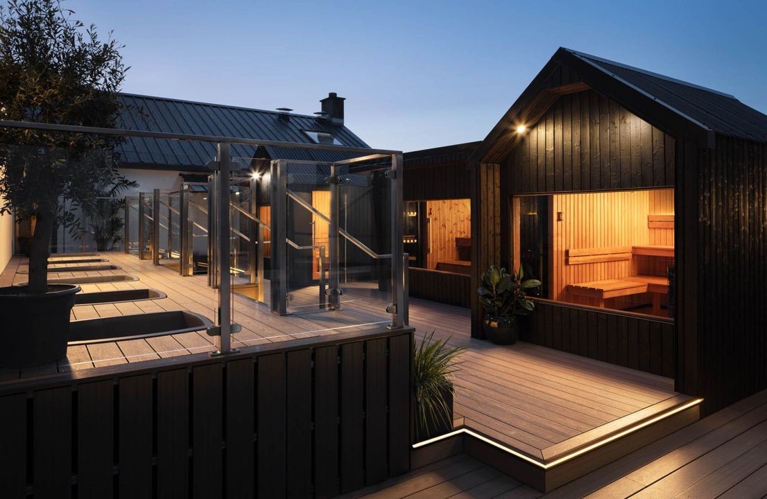 Lit saunas on a roof top at dusk