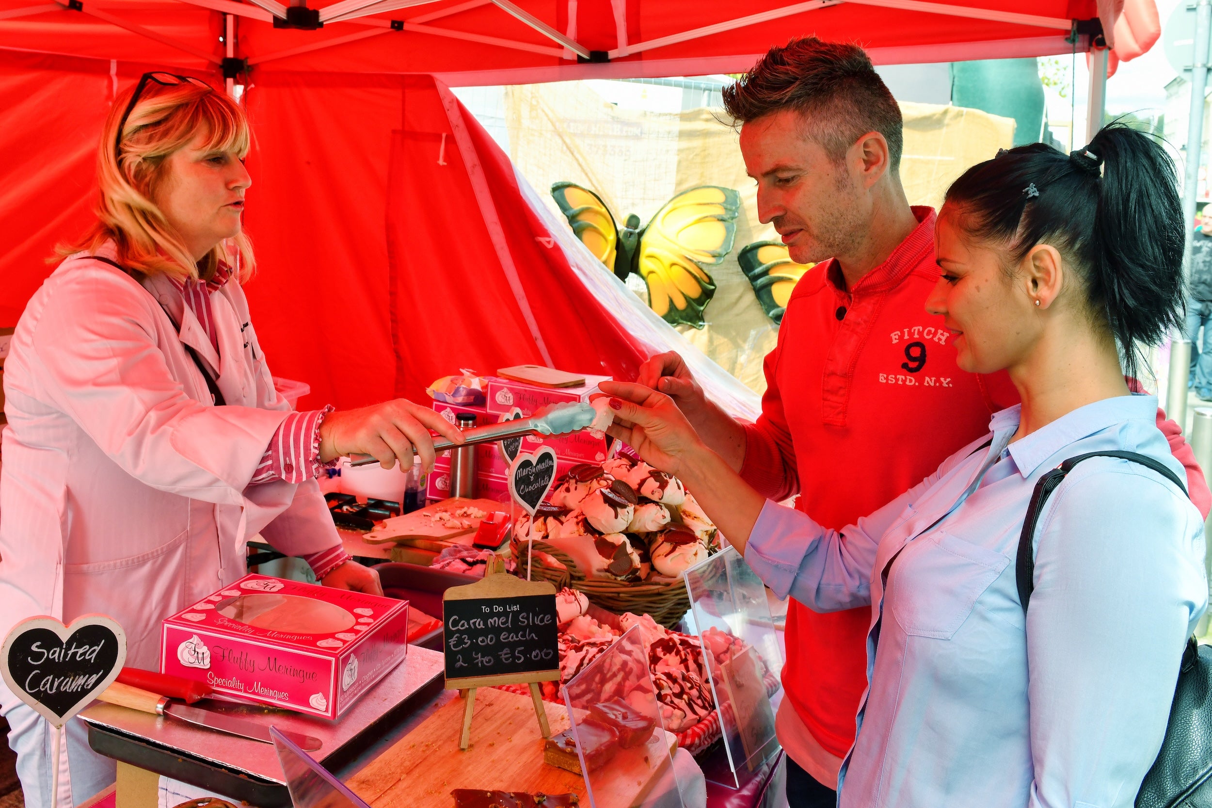 People trying food at a market in Waterford