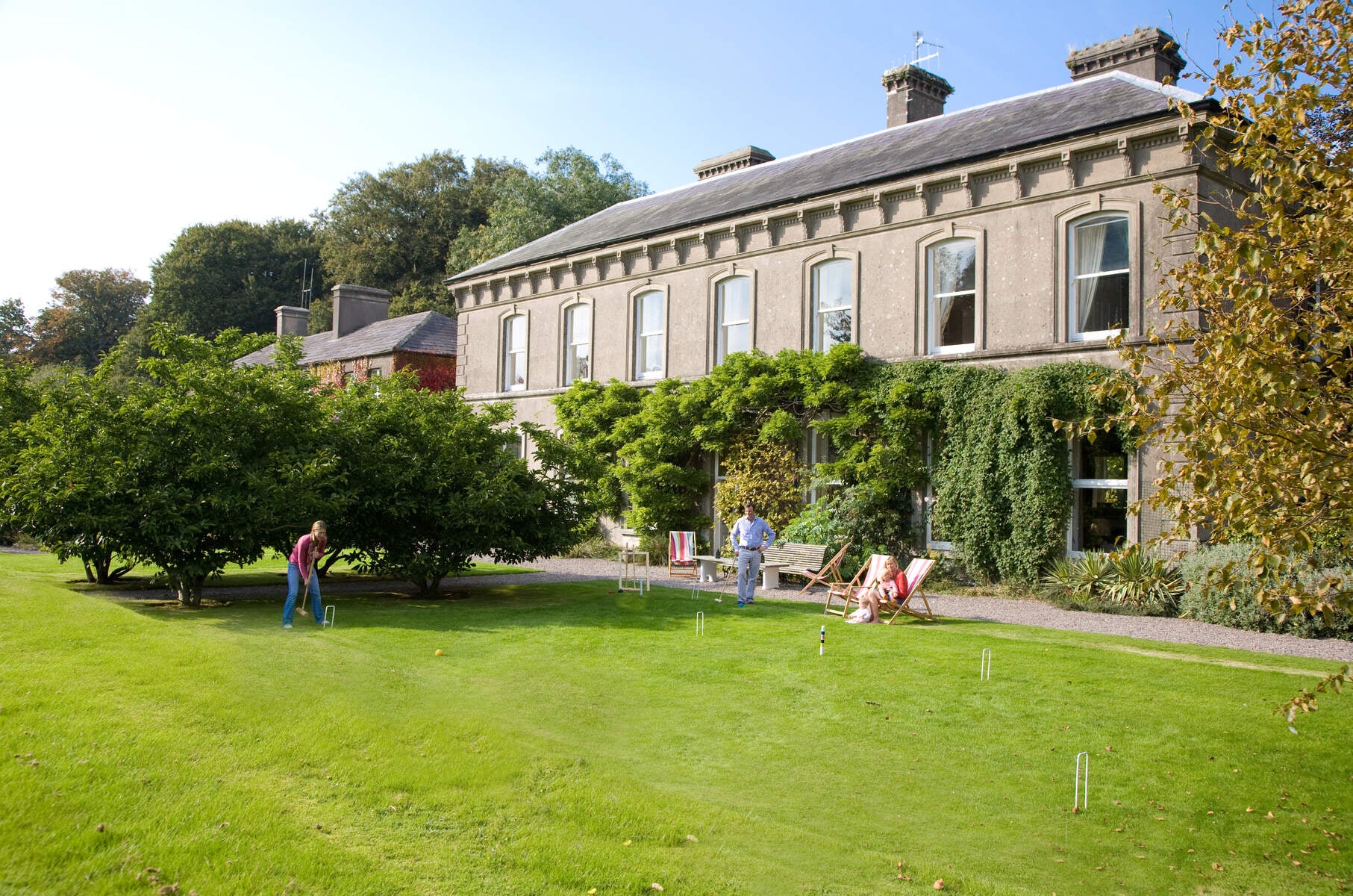 Family playing croquet on the lawn of Ballyvolane House.