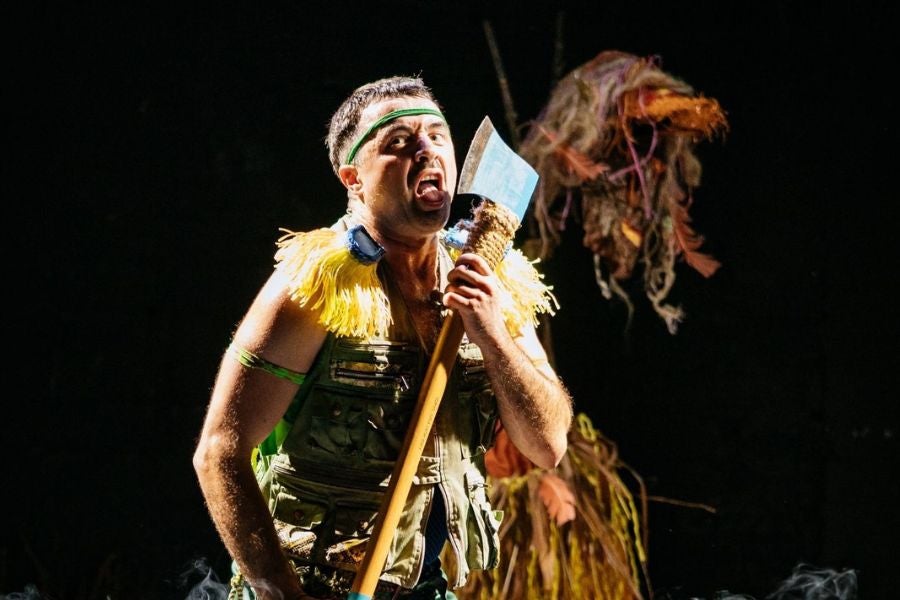 Image of man on stage holding an axe