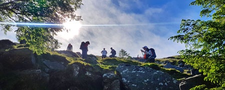 A group of walkers navigating their way along a rocky ridge