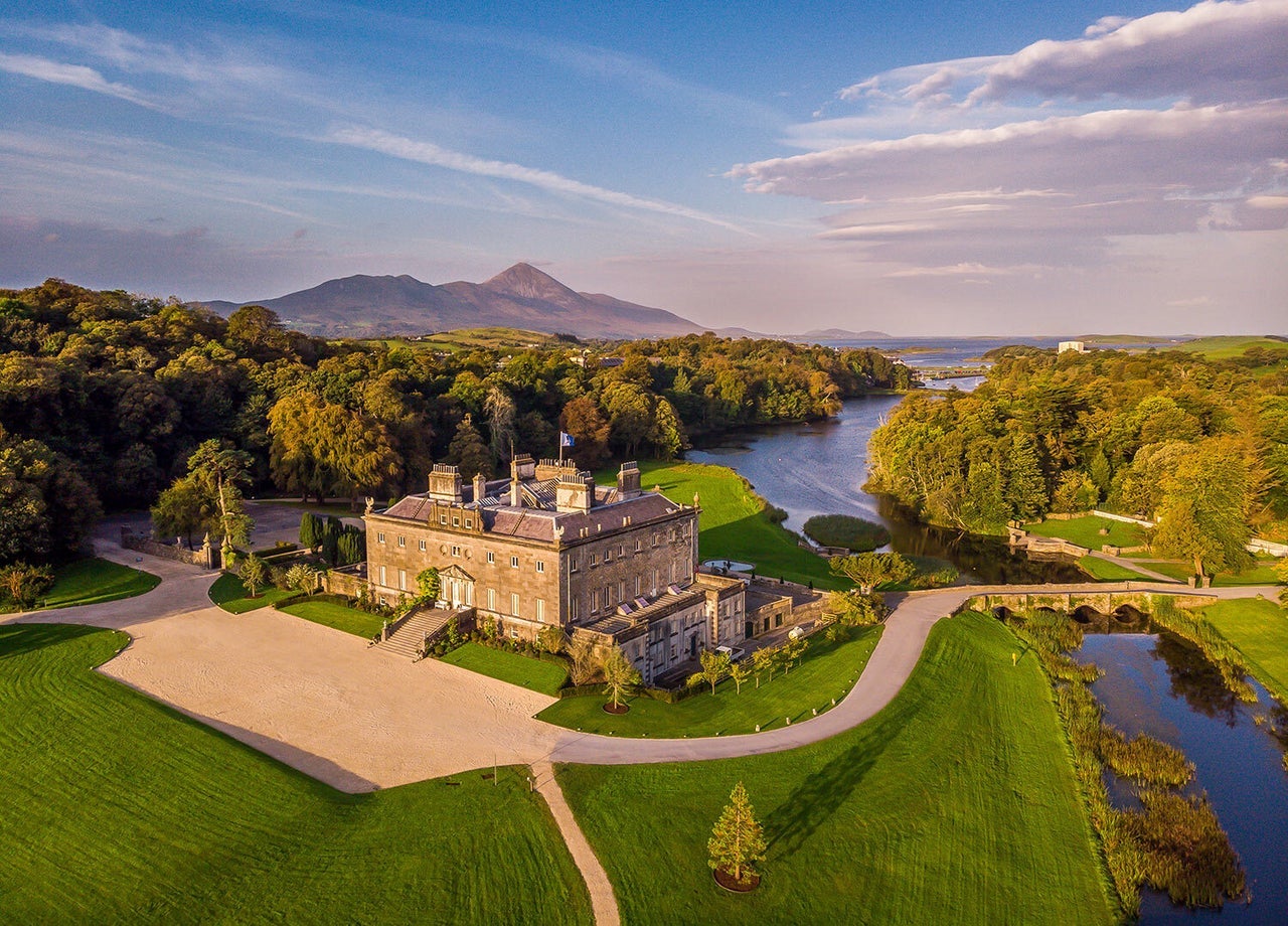 An aerial view of a large period house with an extensive garden