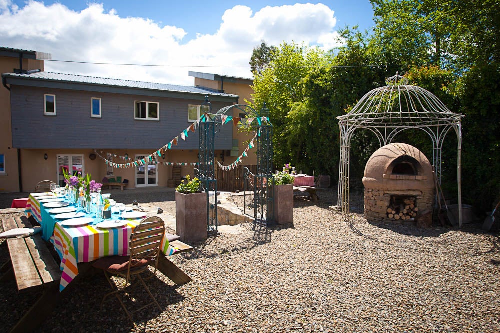 A courtyard set up with a table for outdoors eating.