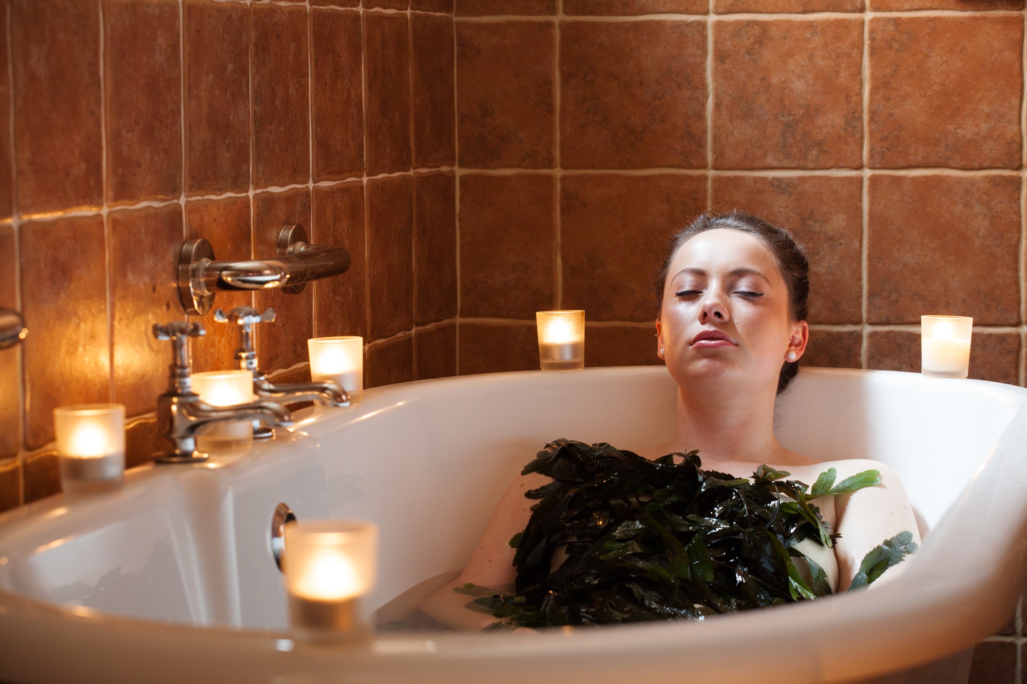 A woman in a seaweed bath at VOYA Seaweed Baths in Strandhill, County Sligo