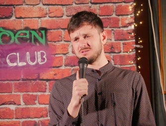 A comedian with a microphone in his hand