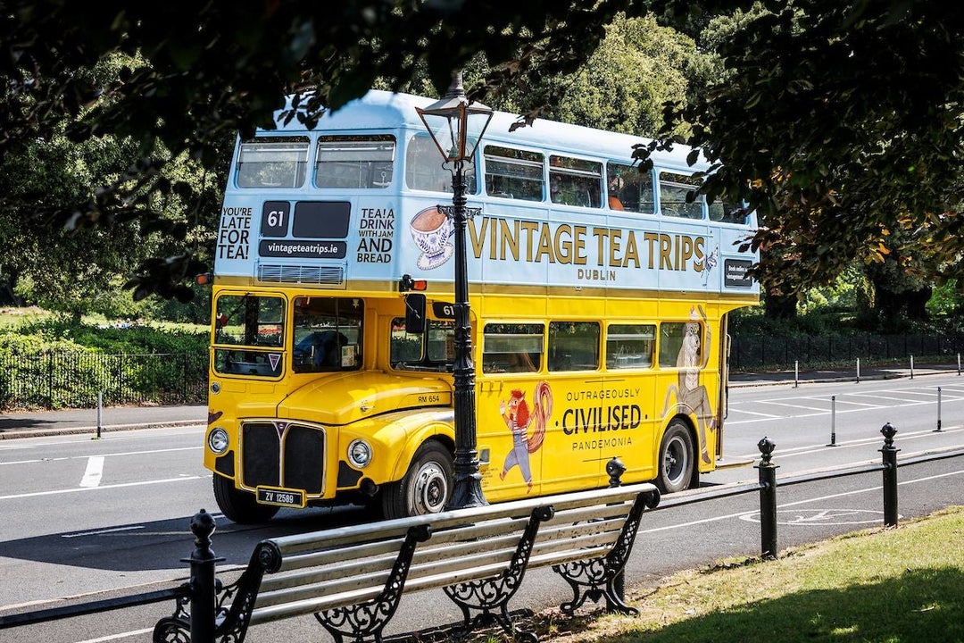 A yellow and blue vintage double decker bus
