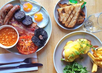 Full cooked breakfast dishes with toast