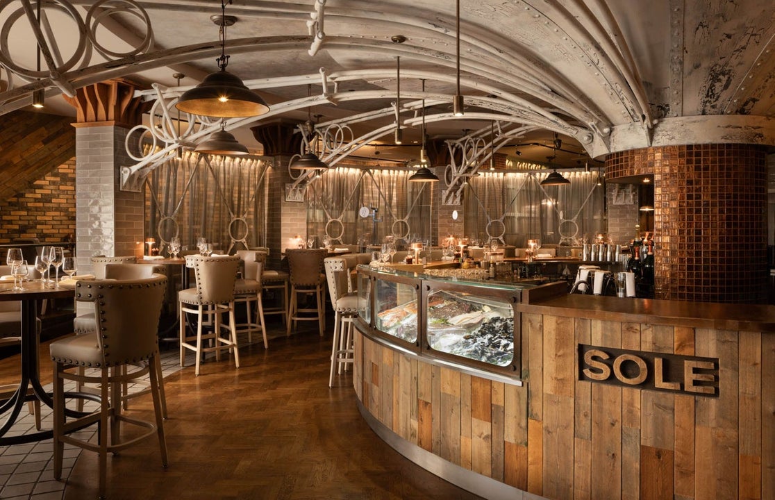Interior of a restaurant with a business name on the bar