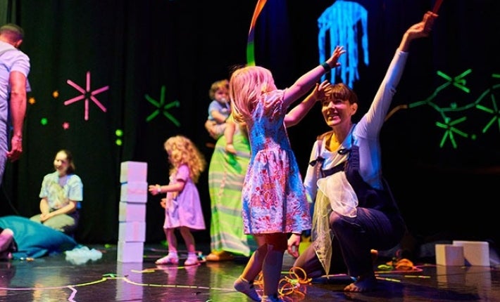 Children and adults playing or moving together