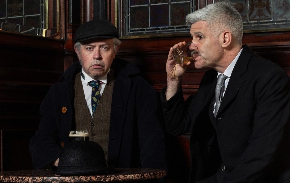 Counterparts & A Little Cloud - 2 men in old fashioned dark suits and ties drinking at a small table in a pub