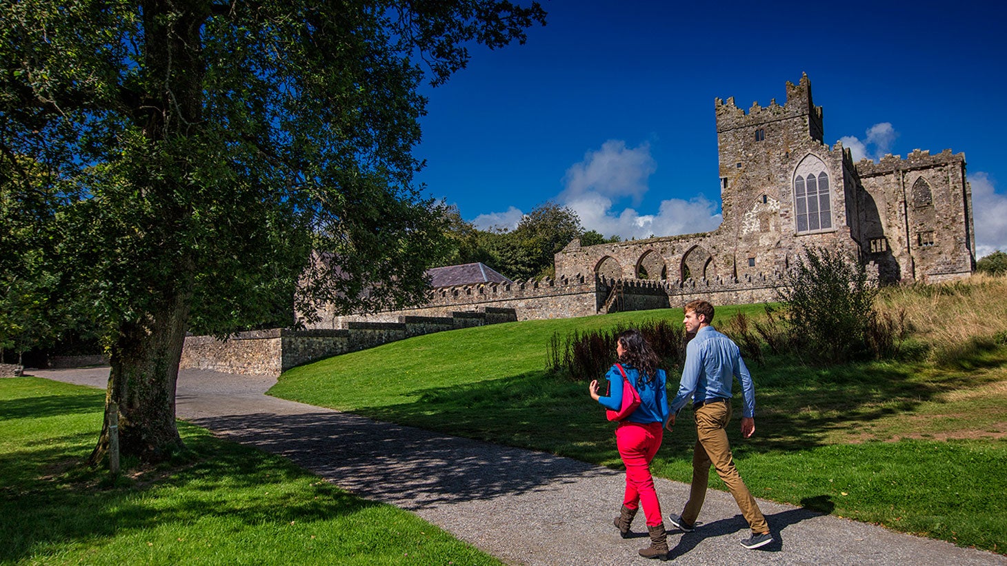 Couple walking towards Tintern Abbey, County Wexford