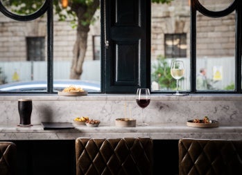Long counter area prepared for dining with a view of a city street