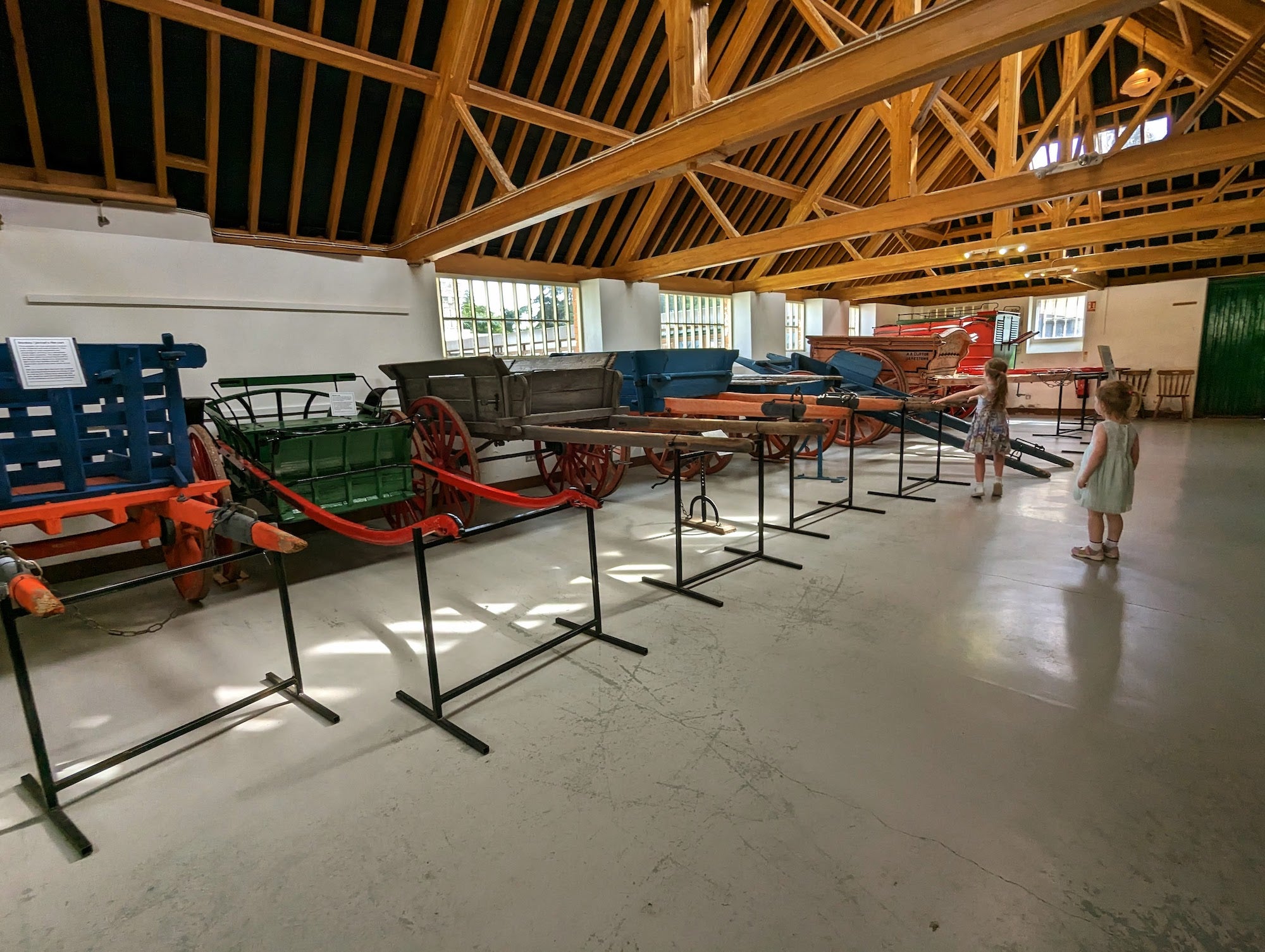 Two kids looking at old carts on display at the Irish Agricultural Museum in County Wexford.