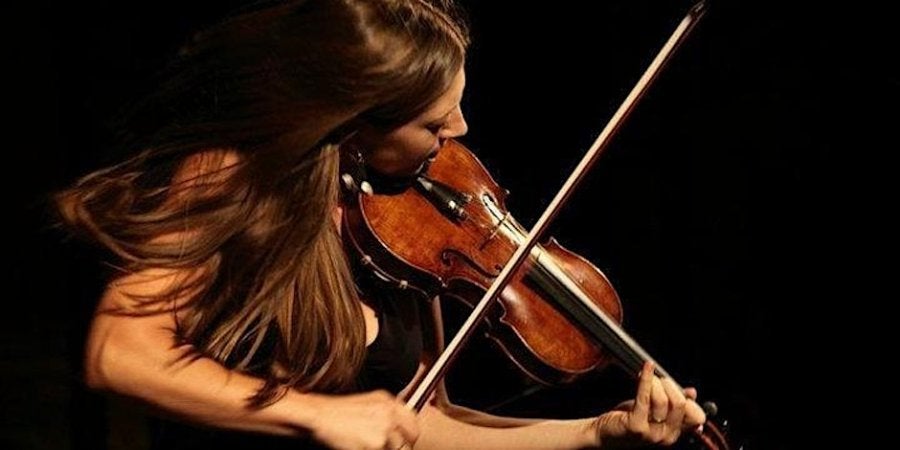 A woman playing a fiddle.
