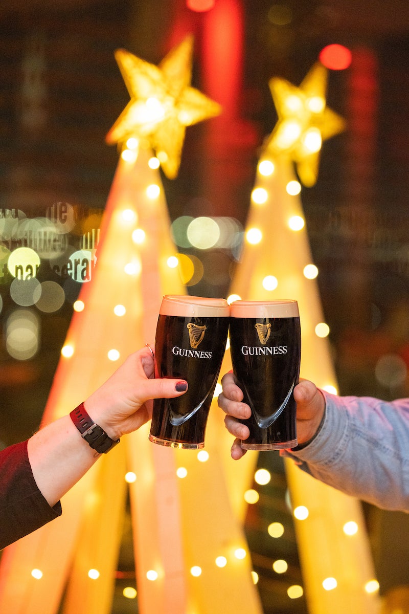 Clinking pints at the Guinness Storehouse at Christmas.