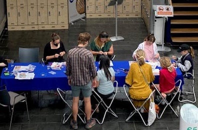 Drop-in for Families: Bealtaine Celebration, a long table with children and adults making things.