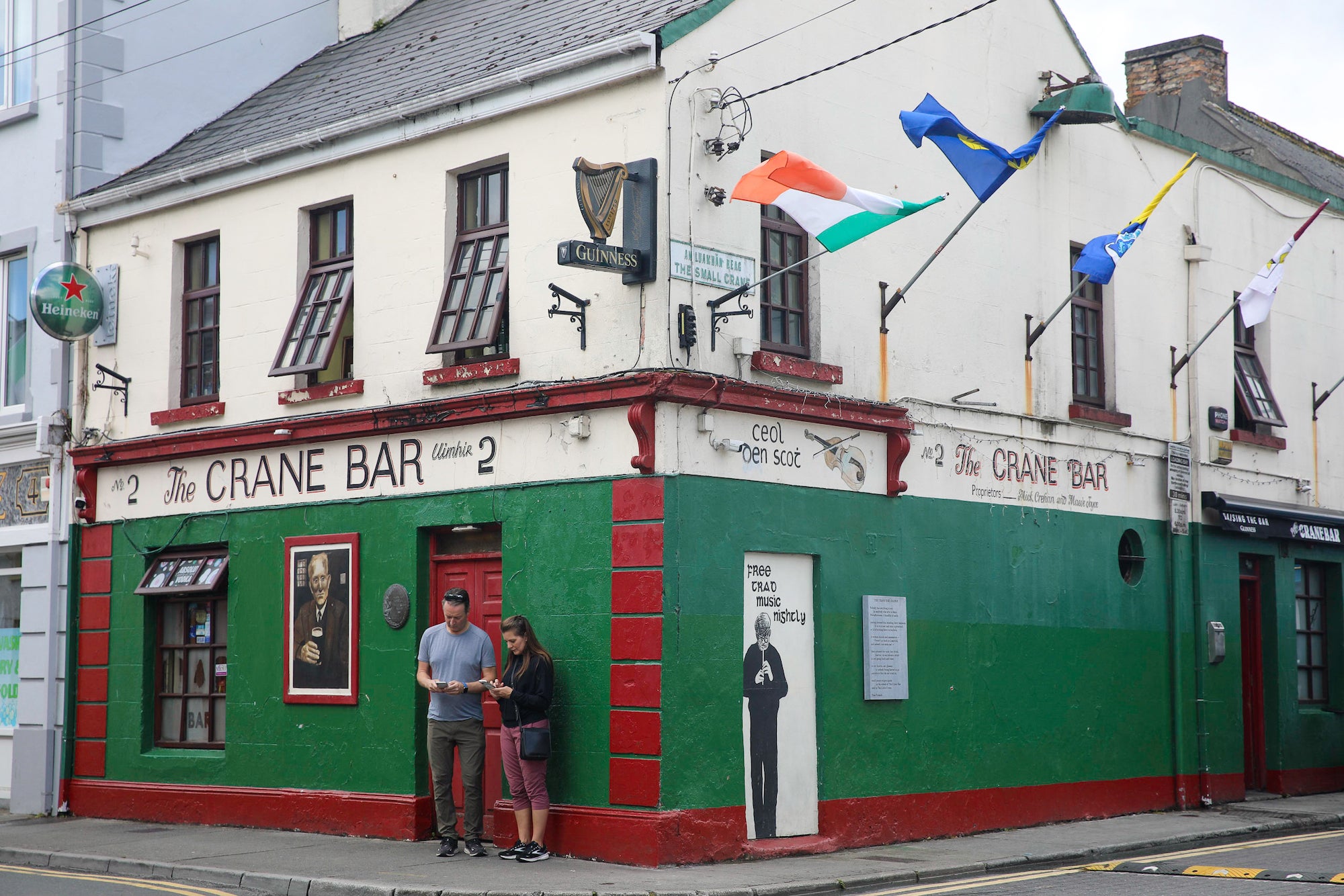 People standing outside of the Crane Bar in County Galway.