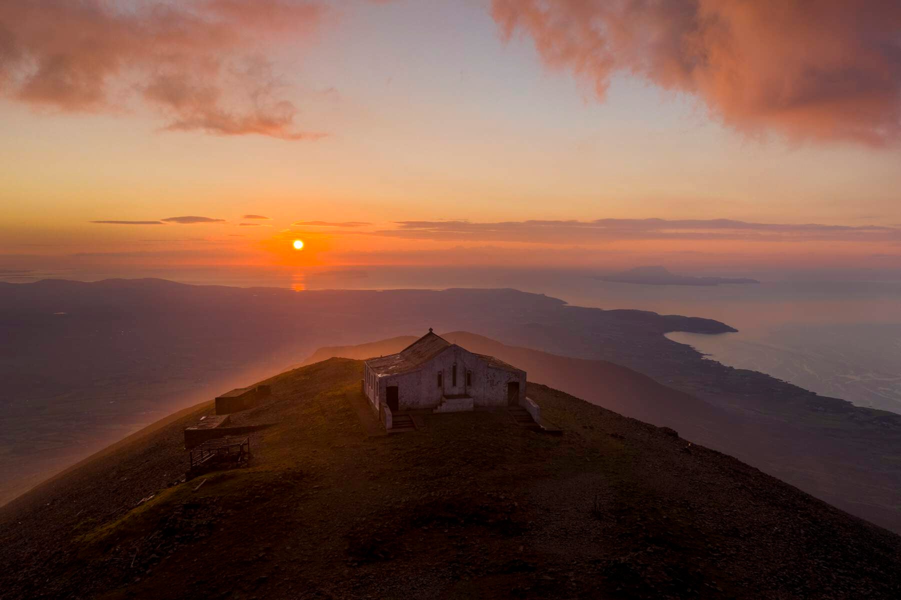 Dramatic view of Croagh Patrick summit at sunset.