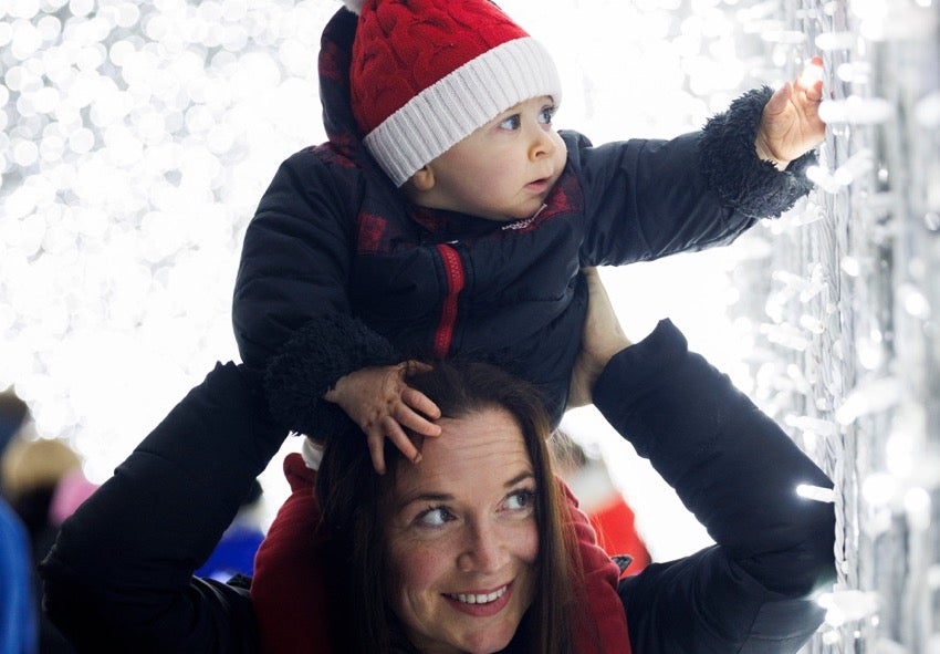 Wonderlights at Malahide Castle - a baby on the shoulders of an adult looking with wonder a white lights