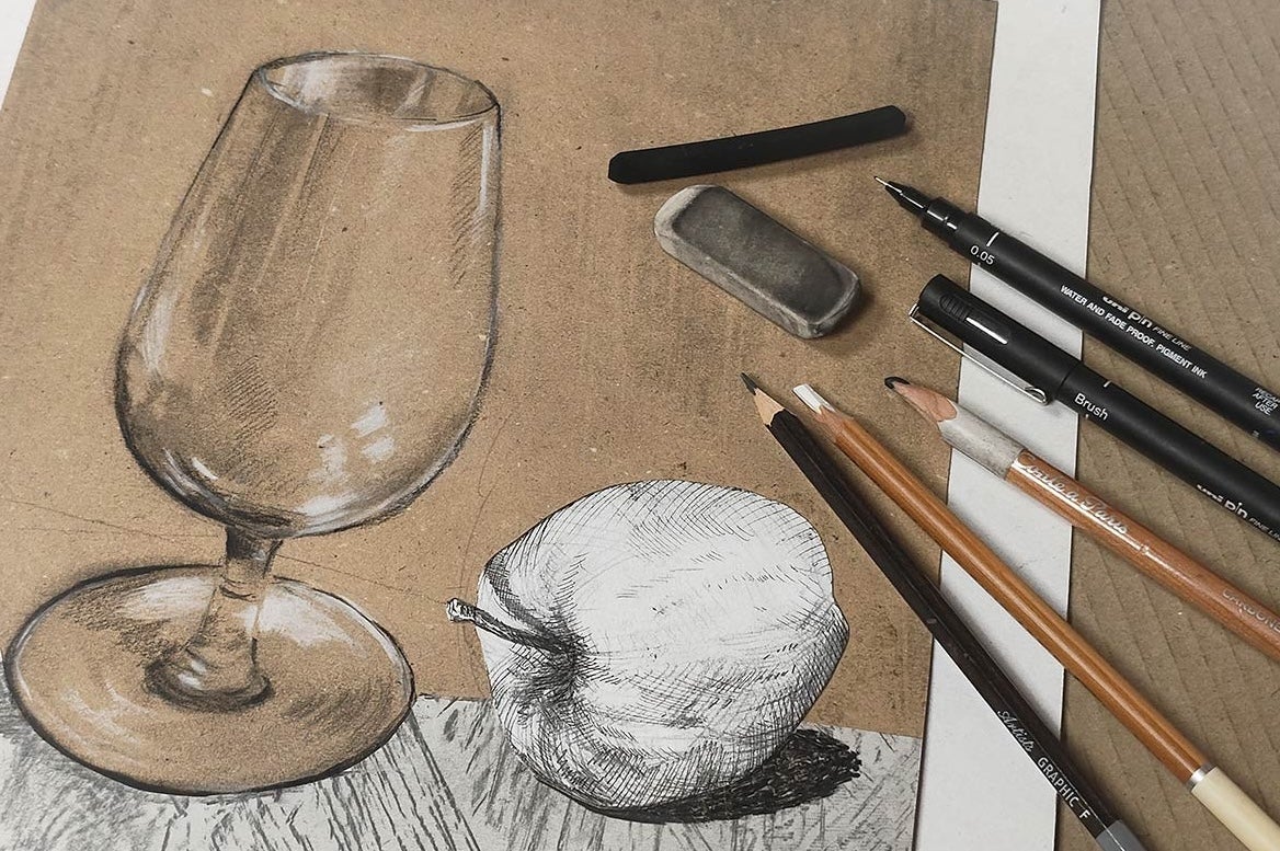 A sketch of a glass and an apple with pencils laid on it.