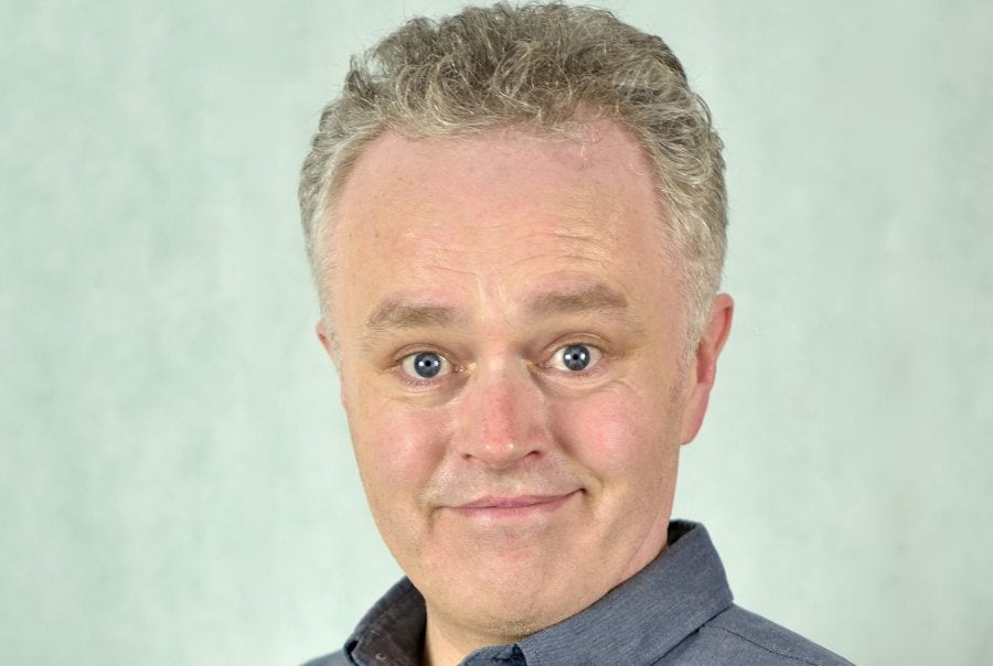Comedian Patrick McDonnell, smiling looking slightly shocked.
