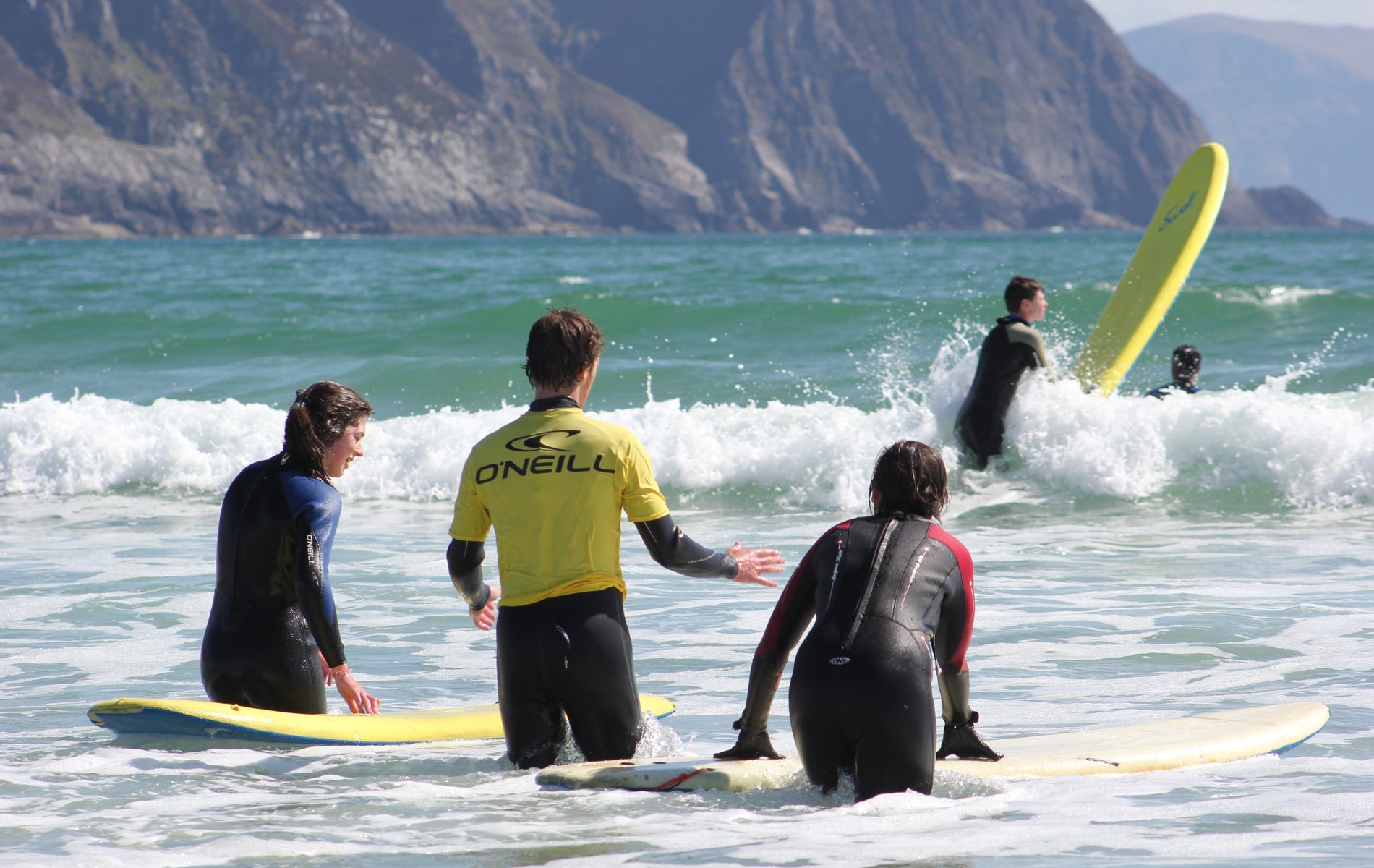 People surfing with their surf boards in the water