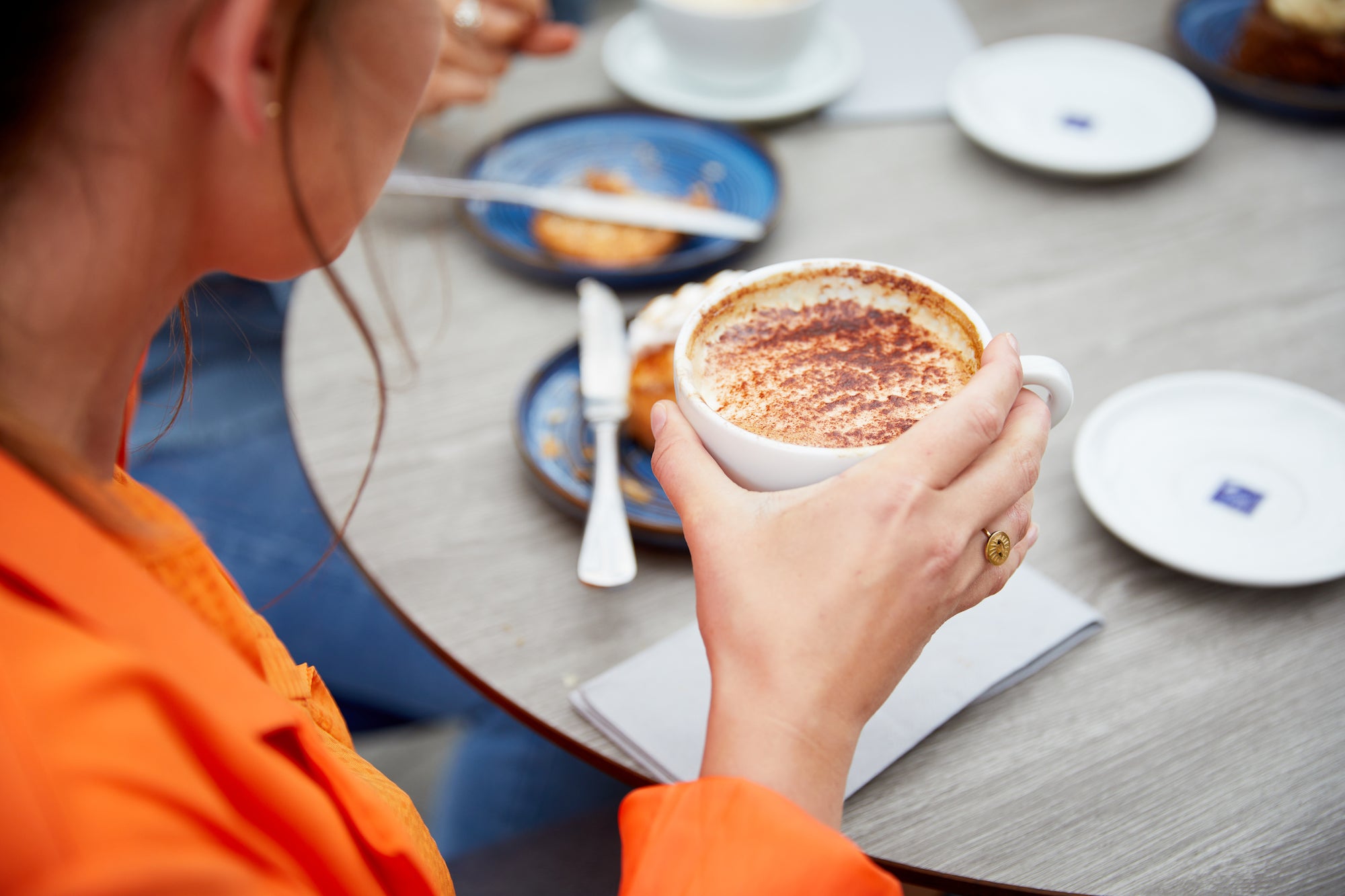 Woman drinking a cappuccino.