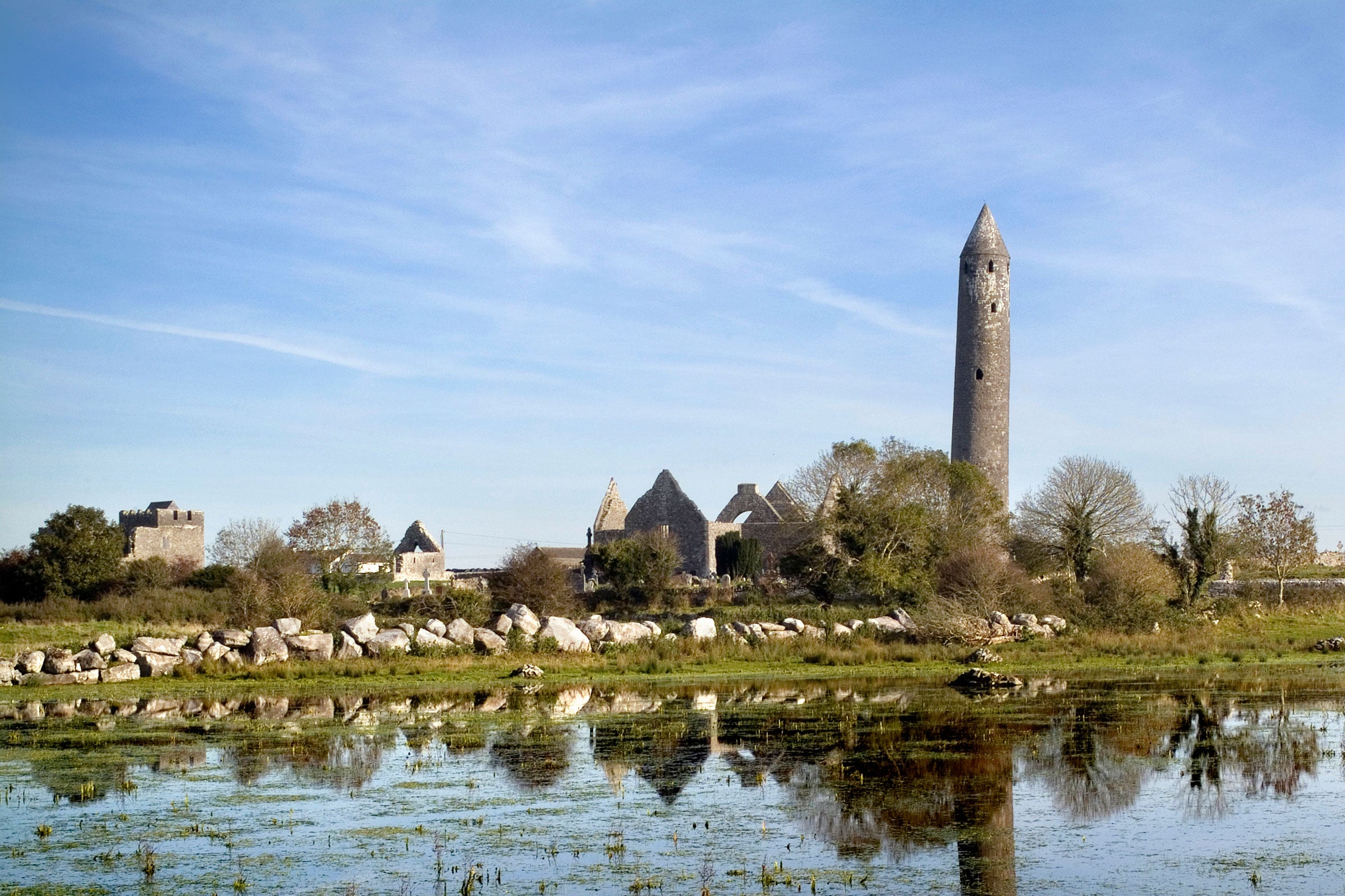 Round tower and churches at Kilmacduagh Monastic Site, County Galway