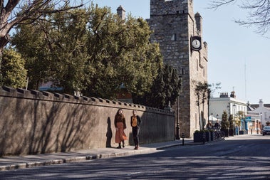 Two people walking on a footpath in Dalkey, Co Dublin
