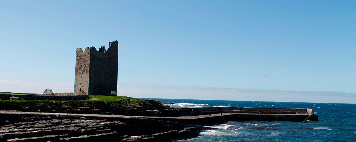 The ruins of a tower overlooking a pier