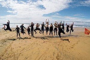 Group mid jump on the beach