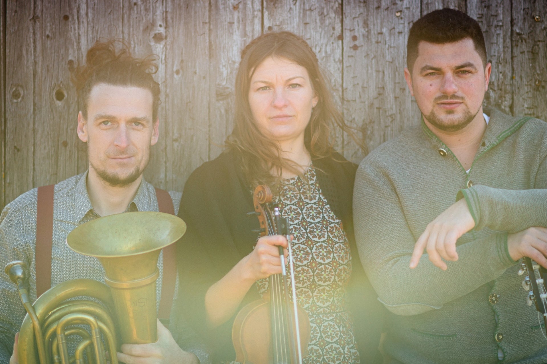 Slightly blurry photo of 3 musicians with instruments