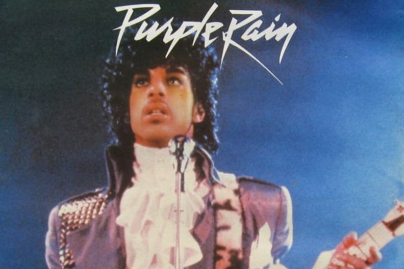 When Doves Cry: A Prince Film Night, a man on a stage playing a guitar with a worried look on his face.