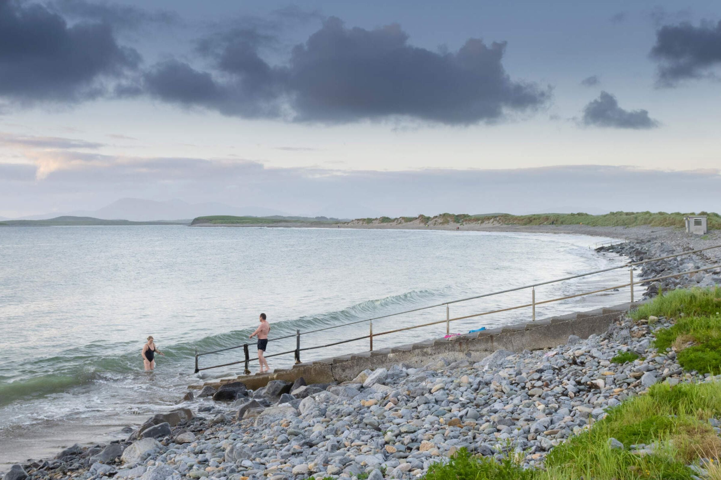 Two people getting into the Atlantic Ocean at Bertra Beach near WestPort in Mayo.