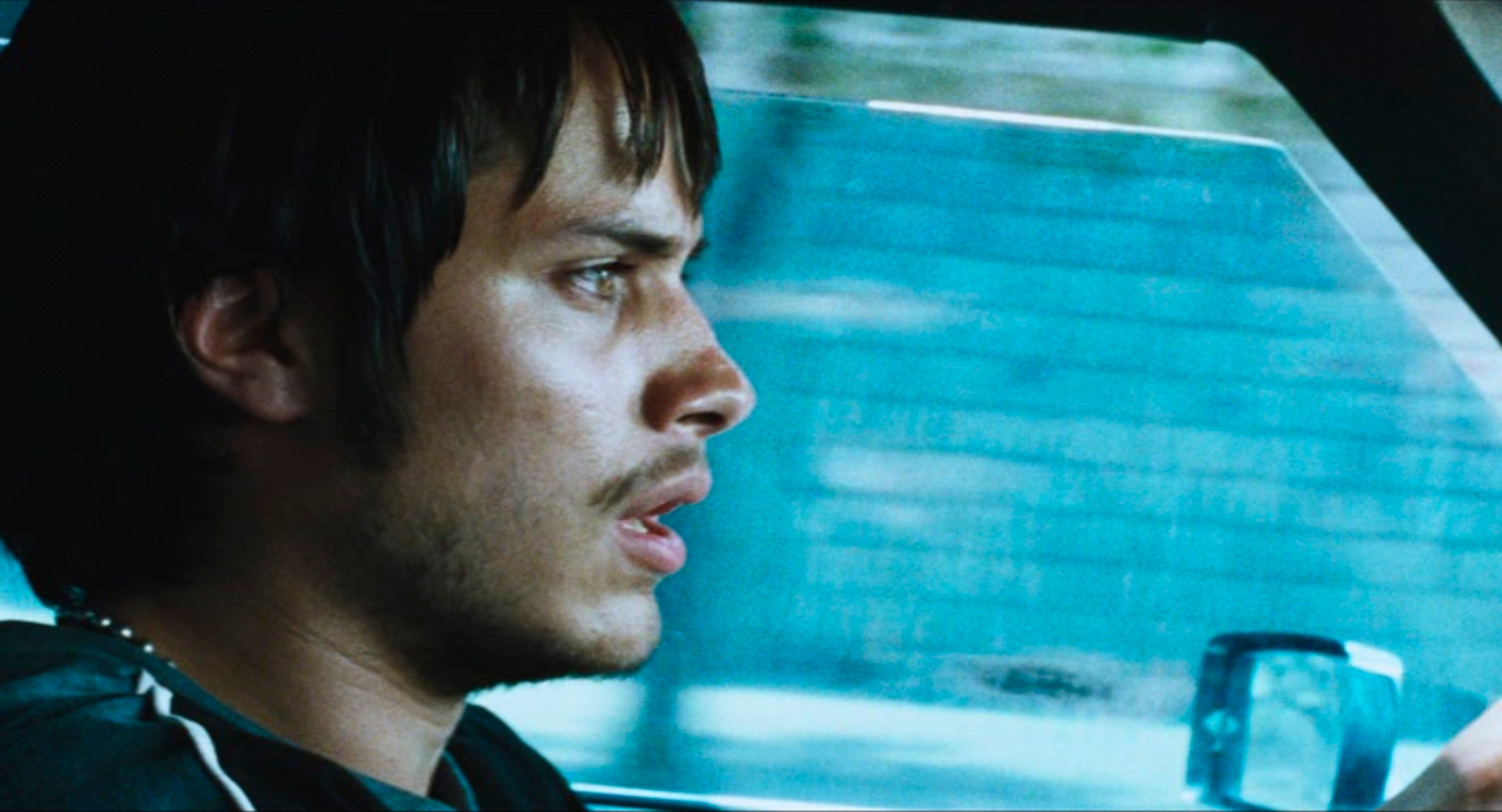 A worried man driving a car.