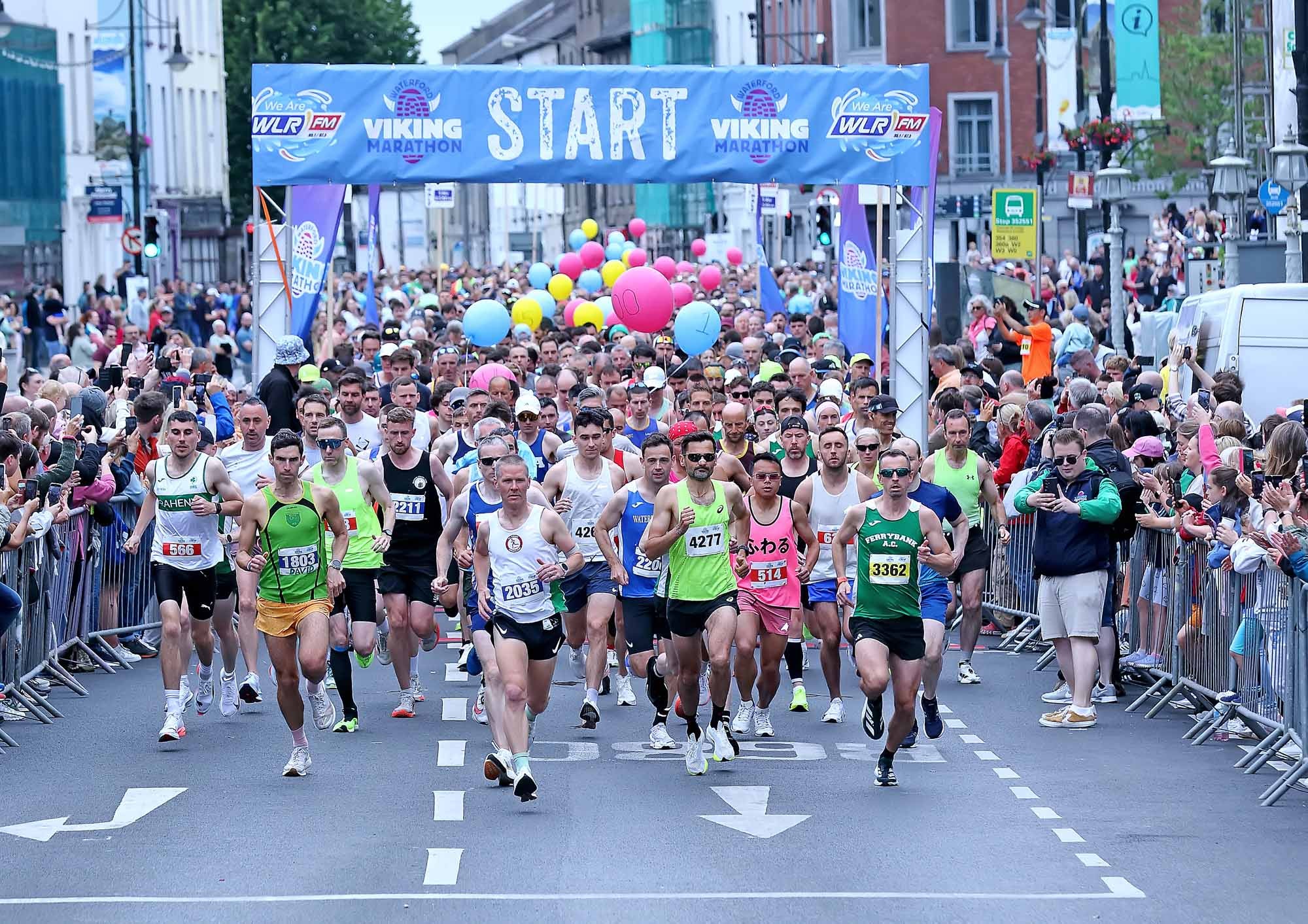 Waterford Viking Marathon 2026, lots of people running at the start of a marathon in a city.