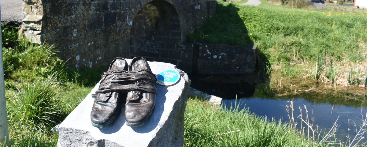 Bronze shoes sculpture along a walking route