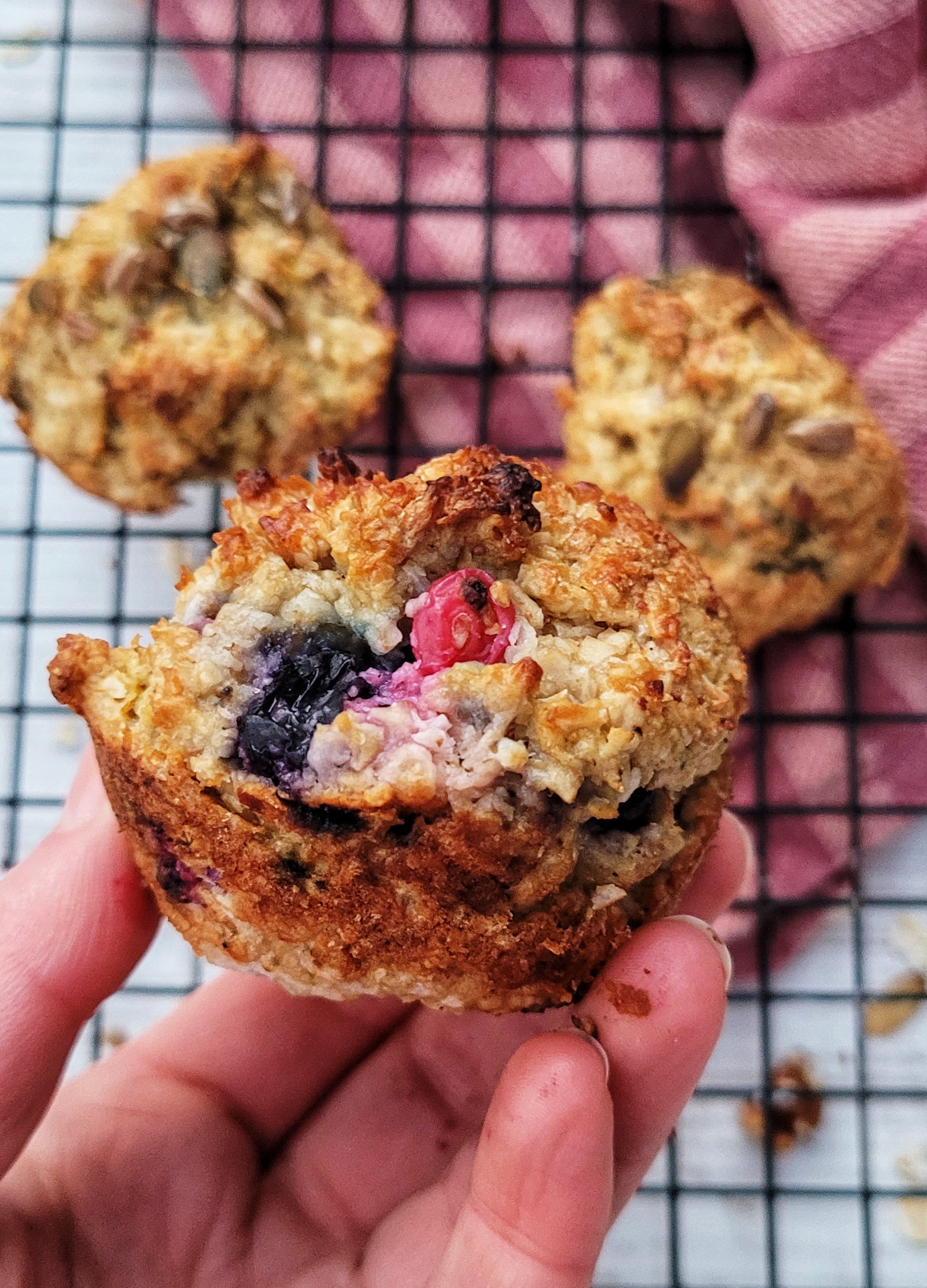 A hand holding a fruit scone 