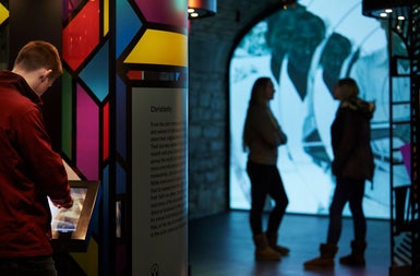 People looking at an interactive exhibit