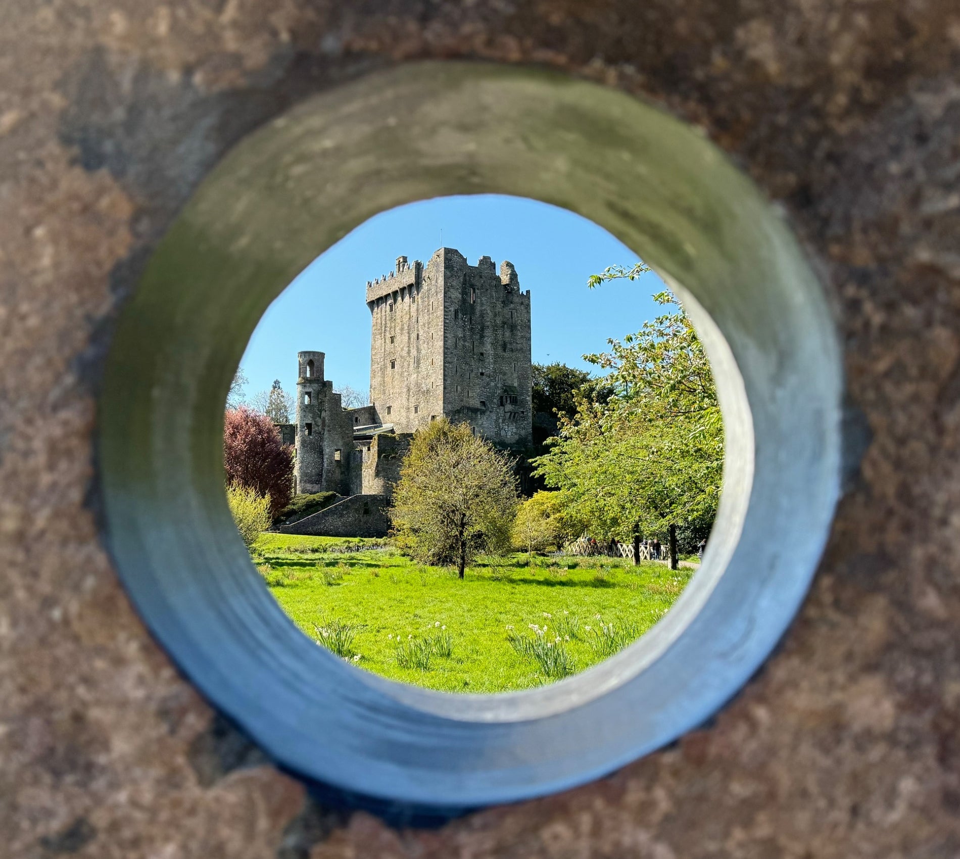 A view of a castle through a circular hole