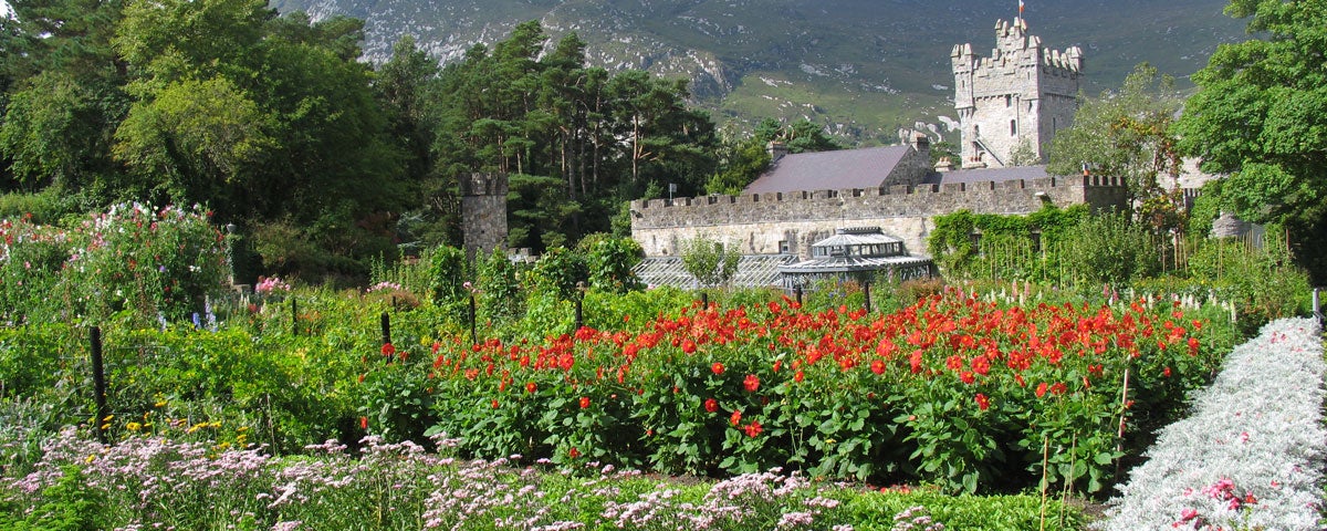 Glenveagh Castle surround by trees and colourful flowers