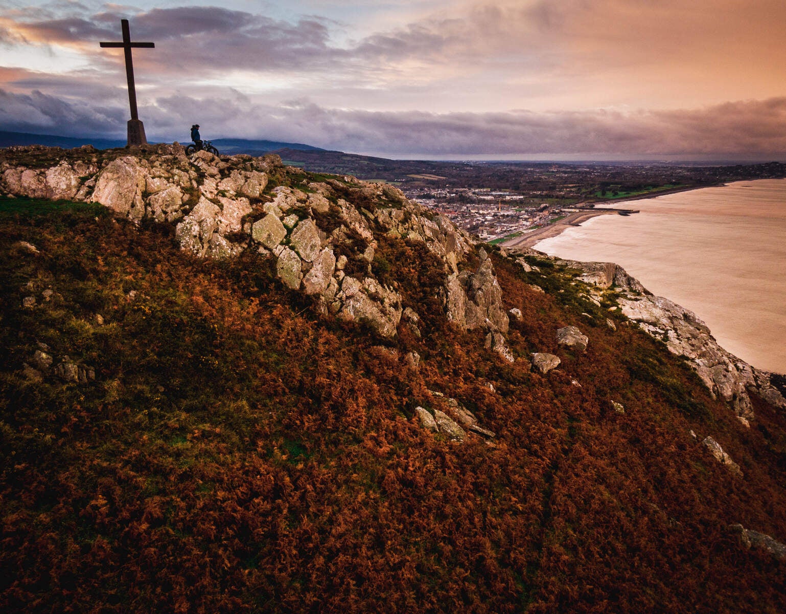 Cross on a hill looking out to sea with Bray in the background
