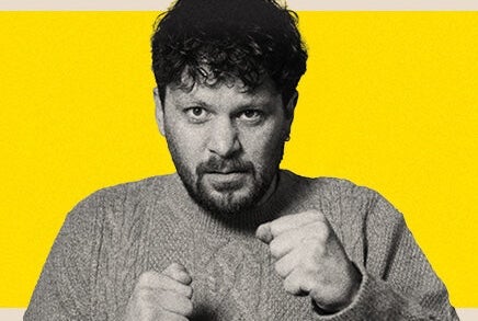 Killian Sunderland, Killian Dollar Baby - a man in knitted jumper holding his hands up in 2 fists.