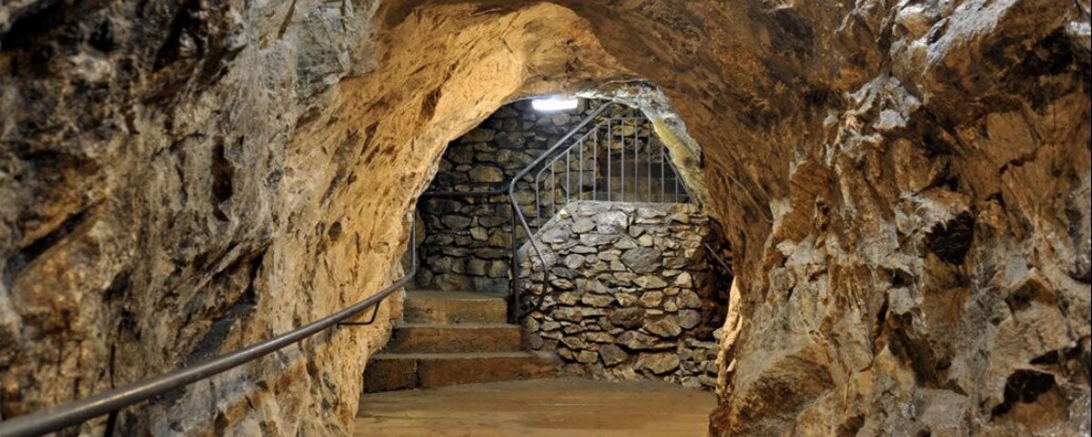 Inside the Glengowla Mine with steps in the distance and a hand rail in the foreground