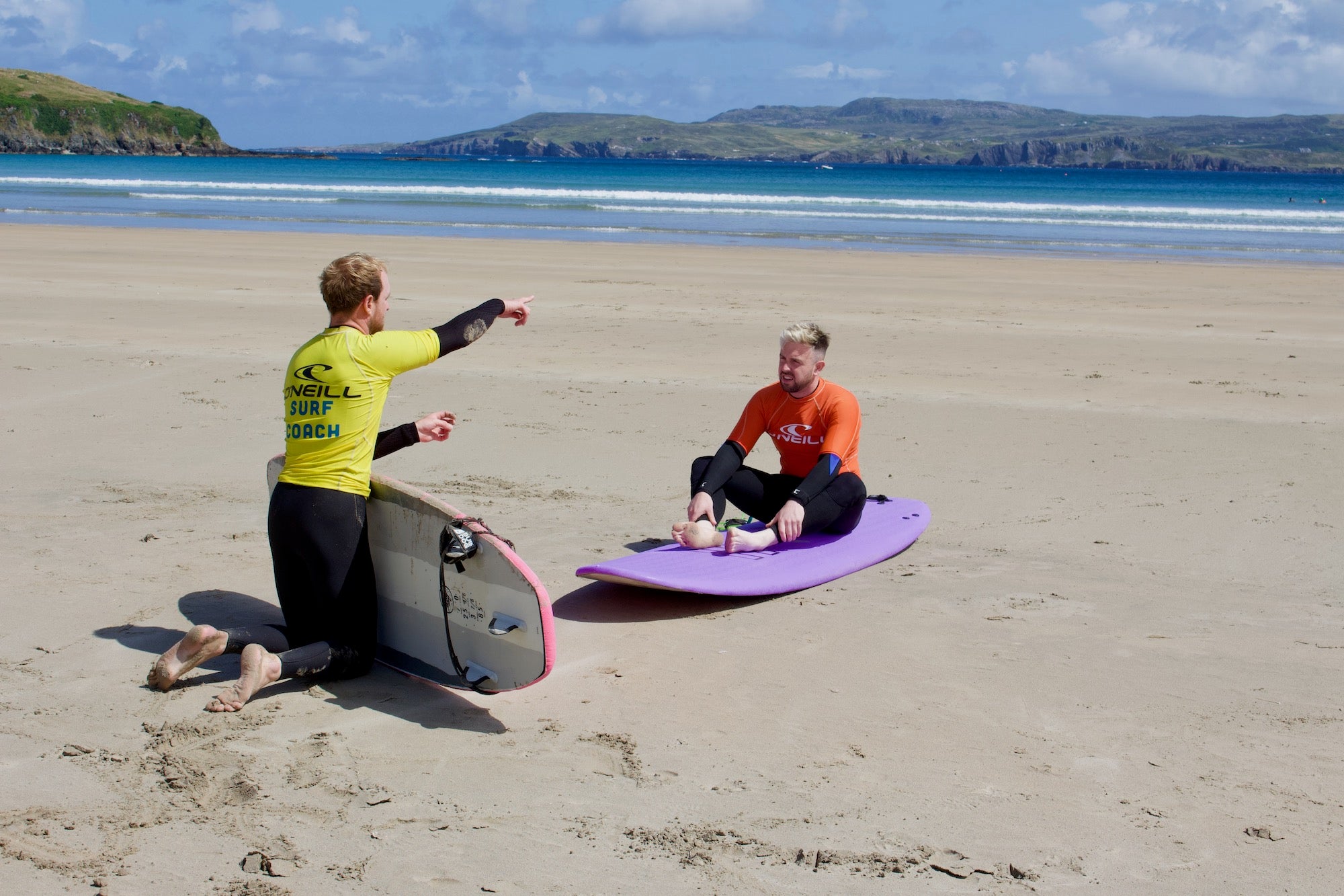 A man getting a surf lesson from Narosa Surf School in Dunfanaghy in County Donegal.