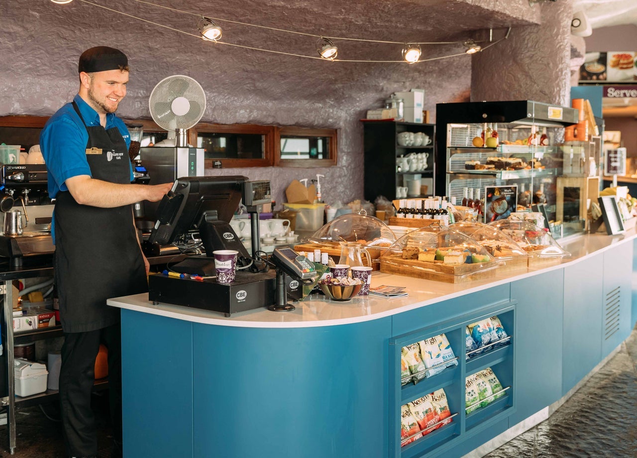 Staff member at a counter in a café