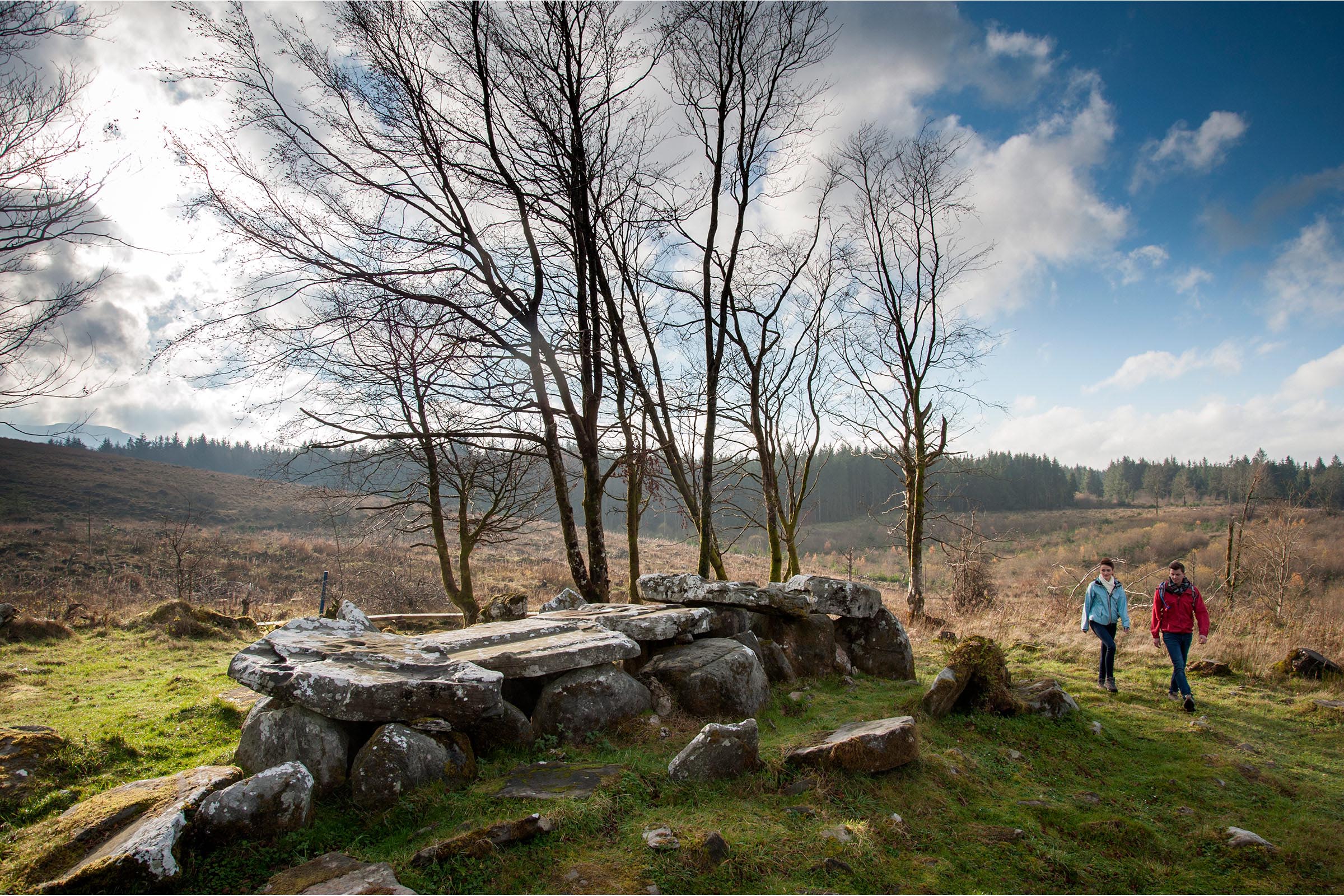 Two people walking through the natural landscape of the Cavan Burren Park, one of the best things to do in Cavan