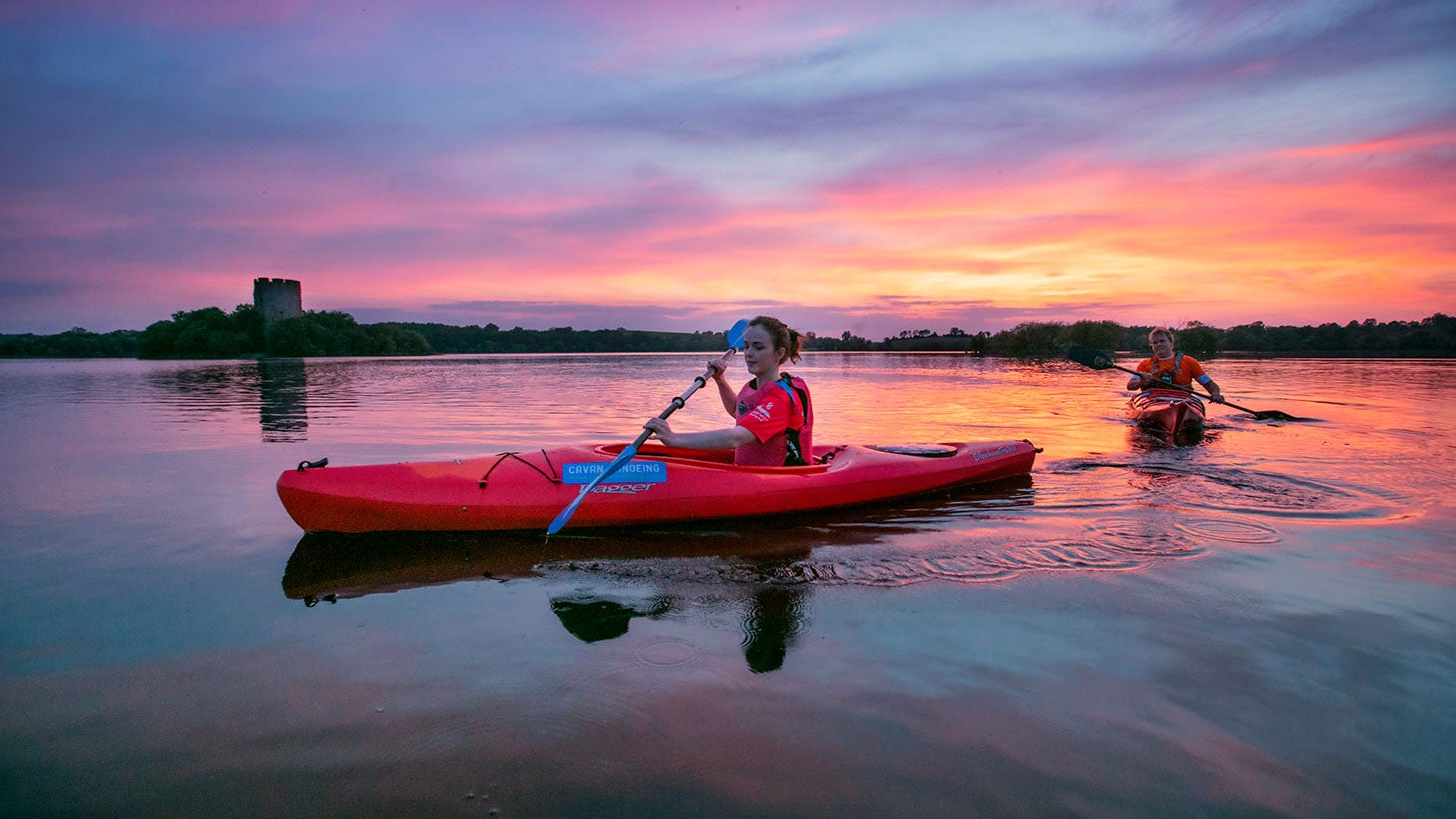 Two people kayaking at sunset on Lough Oughter